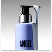 Close-up of a Mugler Angel body lotion pump bottle with white lotion on the dispenser.