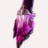  A hand gently holding the Mugler Alien Pulp bottle, with glistening pink berries and drips of liquid cascading from around it