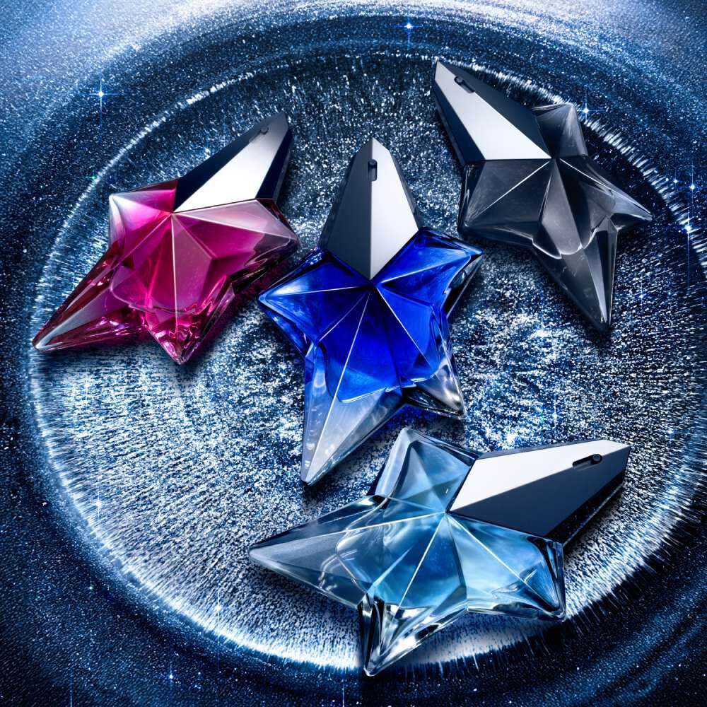 Mugler 50ml Angel Fragrances, Angel Stellar Eau De Parfum, Angel Eau De Parfum, Angel Nova and Angel Fantasm all laid down on a stary galactic background. 