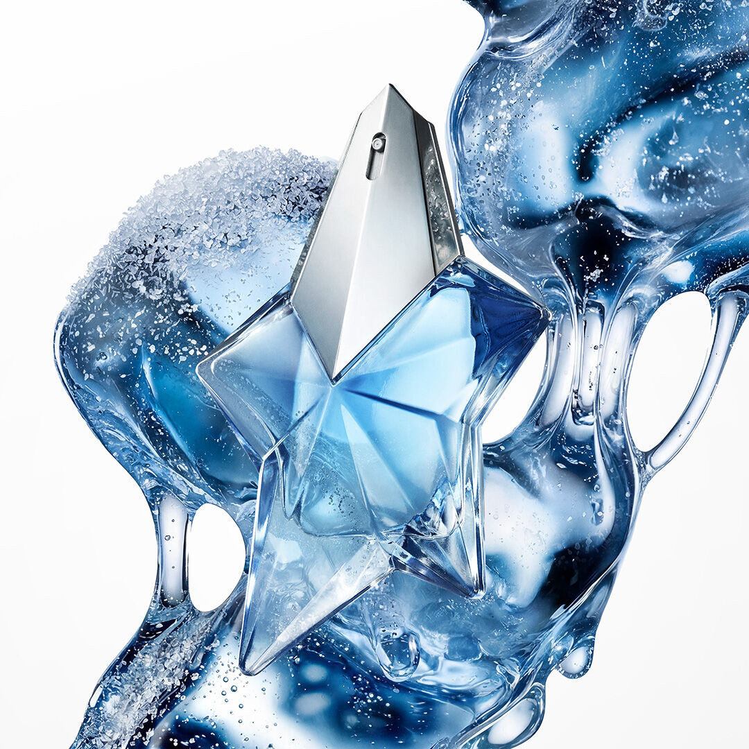 Blue Angel Mugler star perfume bottle with icy, fluid blue abstract backdrop