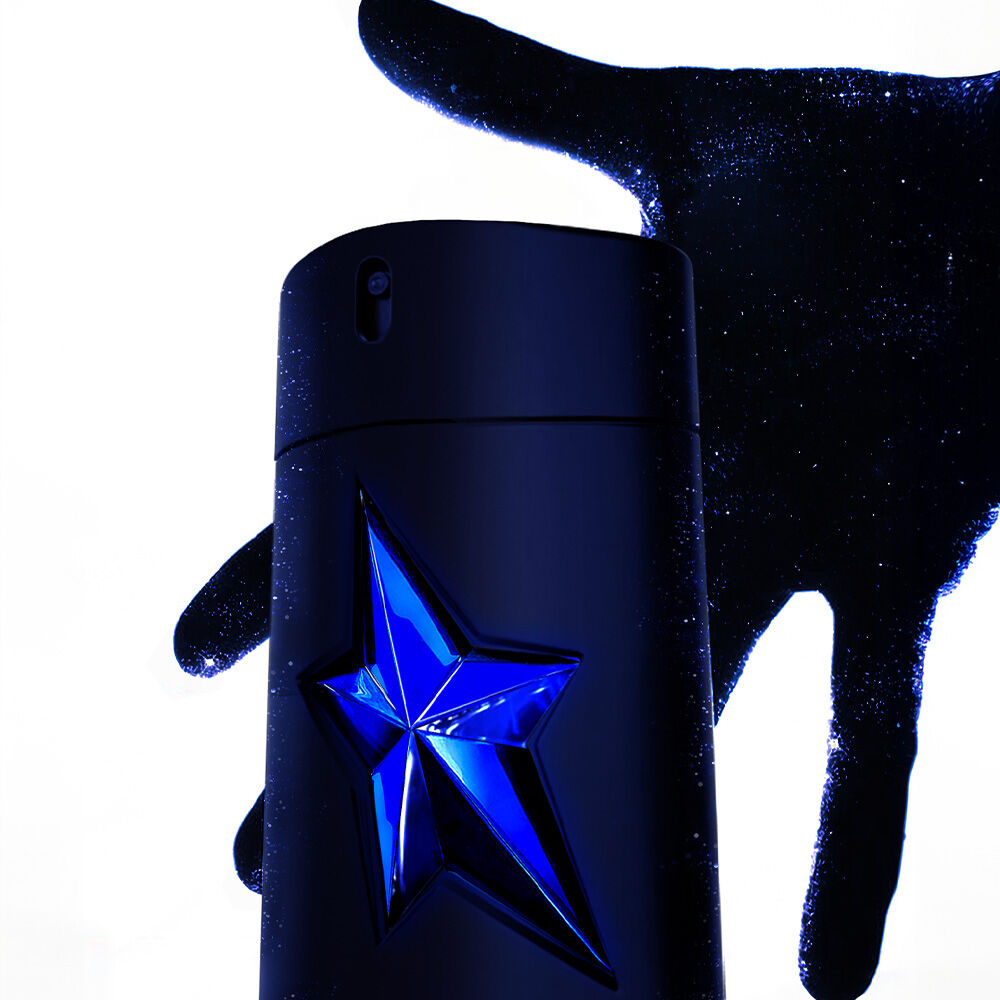  A*Men Stellar Eau de Parfum bottle is partially encased by a hand, creating a dramatic visual effect against a white background.