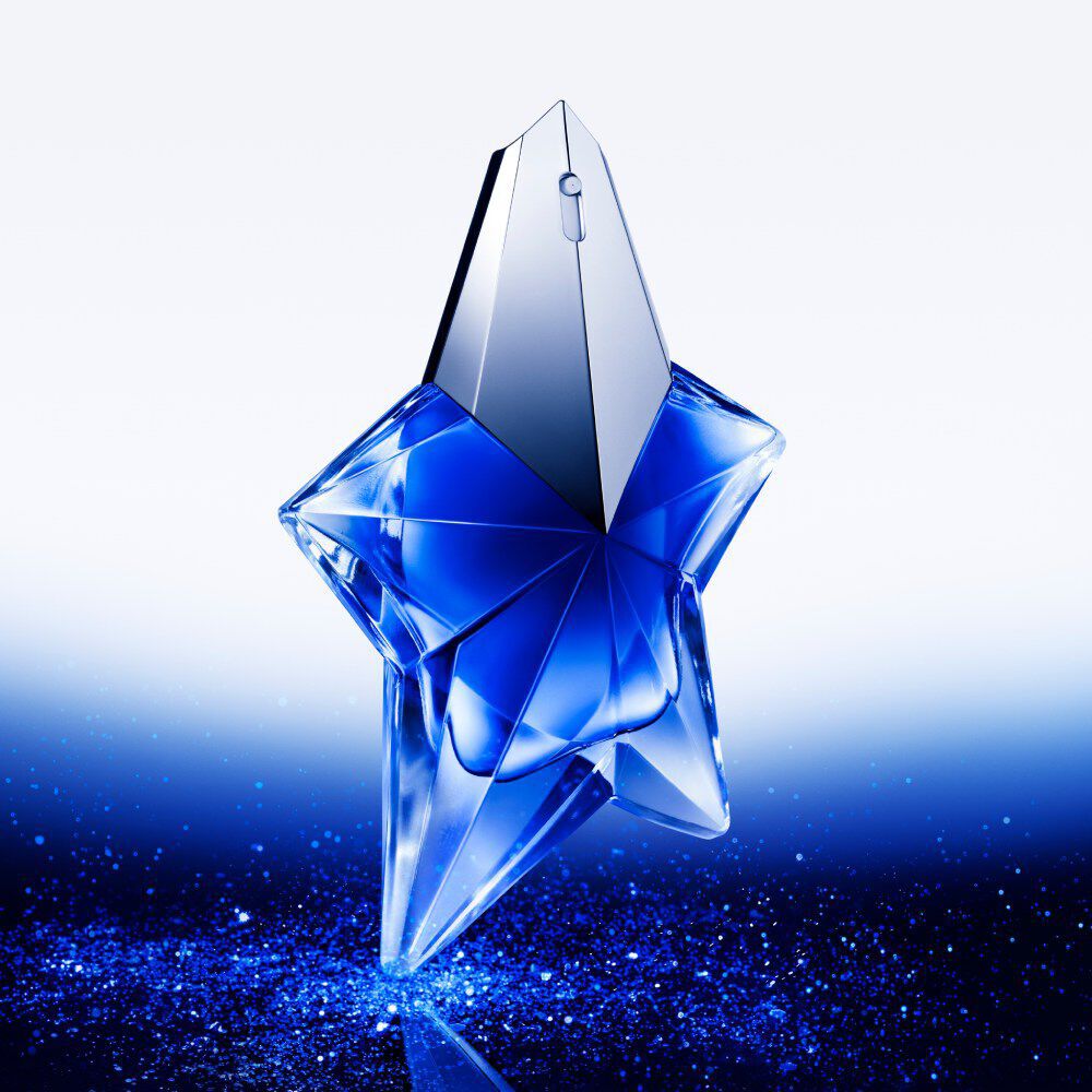 Angel Stellar Eau de Parfum bottle standing up, against a backdrop of blue sparkle which is the main colour of the bottle design.