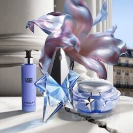 A Christmas tree creatively constructed from various Angel colorful perfume bottles, showcasing unique shapes and designs.