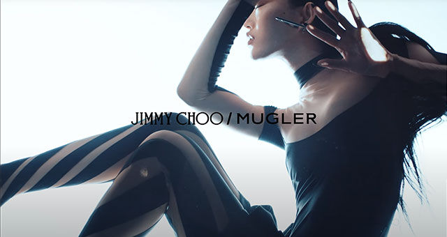A model striking a pose in a stylised shoot for a Jimmy Choo and Mugler collaboration, showcasing fashion and artistry.