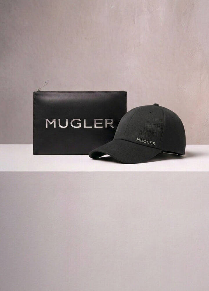 A Mugler branded black pouch and a black baseball cap displayed on a neutral surface, representing the rewards boutique gifts.