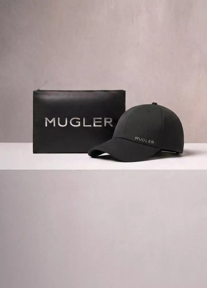 A Mugler branded black pouch and a black baseball cap displayed on a neutral surface, representing the rewards boutique gifts.