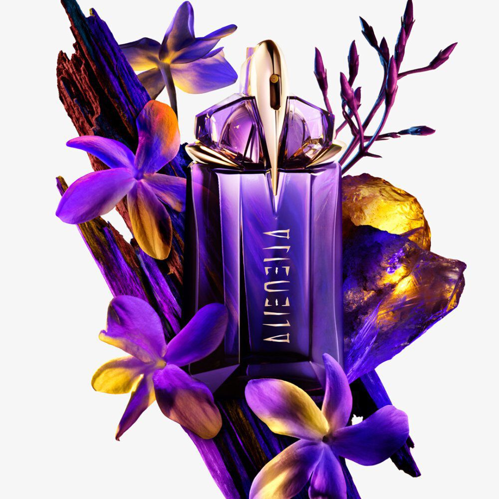  "Purple Alien perfume, flowers, wood, and amber crystals on white.