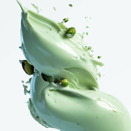 Close-up of light green pistachio paste which is a key ingredient of Angel Stellar Eau De Parfum