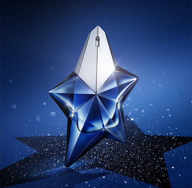 A blue star-shaped perfume bottle with a glossy finish, set against a sparkling blue background.
