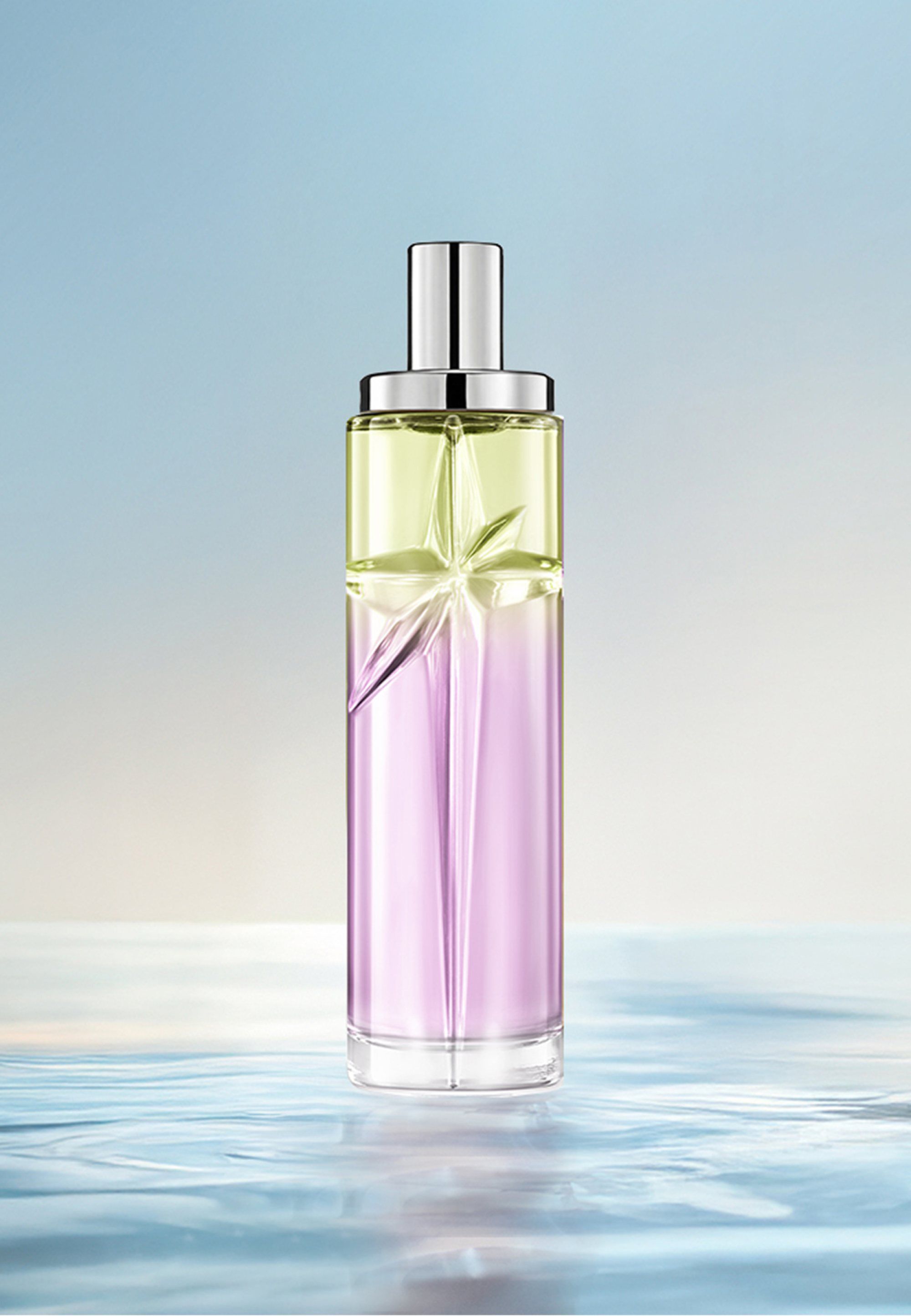 Creamy Delight Starlicious layering recipe: tall bottle with green and amber gradient on water against a soft blue background. Warm, nutty, creamy, slightly sweet scent; 2 sprays Pistachio Praline, 1 Pineapple Musk.