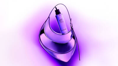 A sleek, modern perfume bottle is positioned on a stylish purple purse, set against a vibrant gradient background of purple hues.