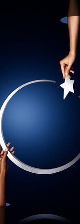 A hand reaches to place a star onto a silver crescent moon against a deep blue background.