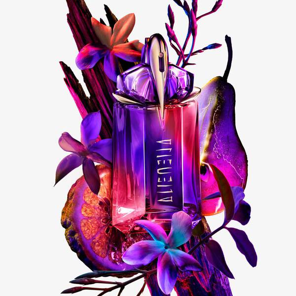 Alien perfume bottle, purple flowers, wood, citrus slice, and pear.