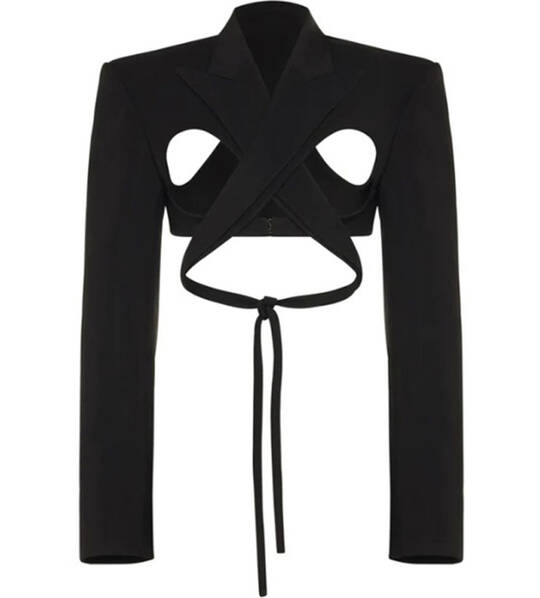 A unique black cropped blazer featuring cut-out detailing and a tie at the waist, designed with a modern, avant-garde style.