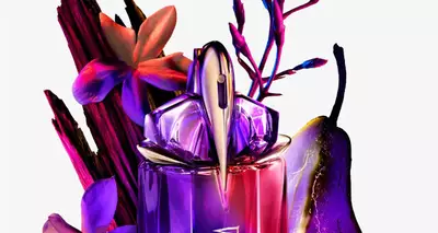 A vibrant perfume bottle surrounded by colorful flowers and a pear, featuring shades of purple, pink, and green.