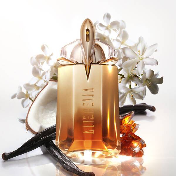 Golden Alien perfume bottle with white flowers, coconut, vanilla, and amber.