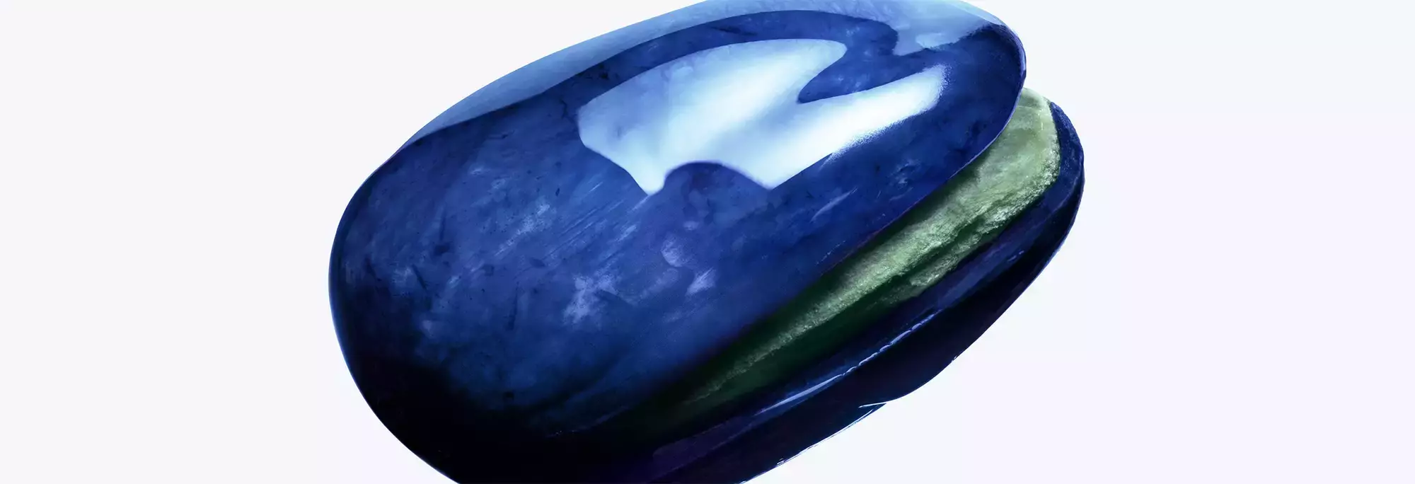 close-up of a pistachio in a mugler-branded cosmic shell.