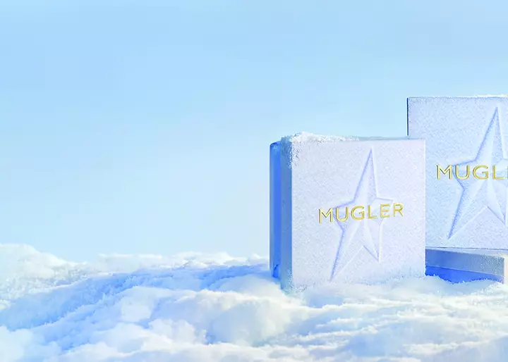 three snow themed Mugler gift boxes in a light icy setting