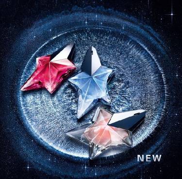 Three Mugler Angel star-shaped perfume bottles in pink, blue, and peach, displayed on a shimmering silver crater surface against a starry night sky background with the word NEW