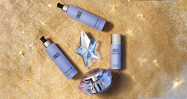 Angel Mugler beauty products on a glittery gold background with star accents.