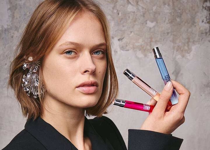 model holding 3 10ml fragrances