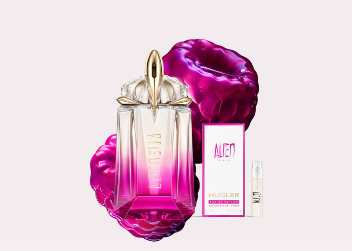 A vibrant purple perfume bottle with "ALIEN GODDESS" written on it, surrounded by glossy magenta berries, set against a dark purple background with a "NEW" label.