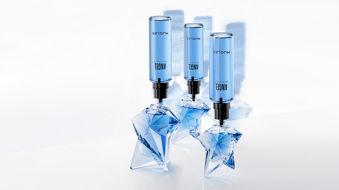 Three star-shaped glass bottles of Mugler Angel Eau de Parfum being refilled 