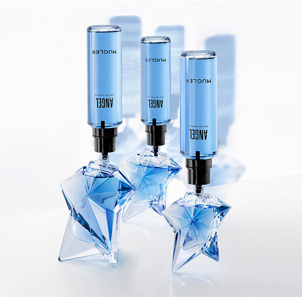 Three star-shaped glass bottles of Mugler Angel Eau de Parfum being refilled