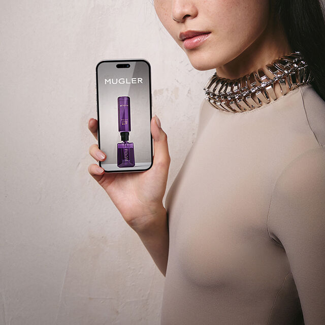 Close-up of model holding a smartphone with a blank screen.​