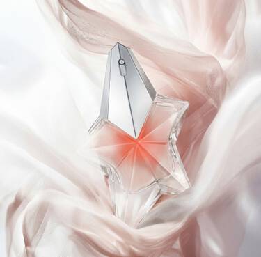 Two purple and pink Alien Hypersense perfume bottles by Mugler, surrounded by large, glossy purple raspberries against a dark background.
