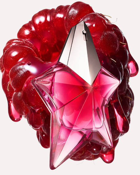 A star-shaped pink metallic perfume bottle positioned over a glossy, melting red raspberry.