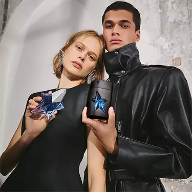 female model holding angel and male model holding a*men