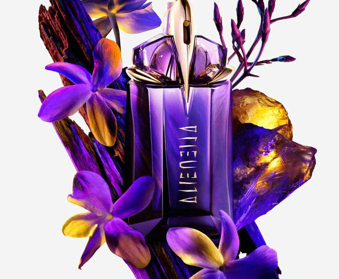 Alien eau de parfum bottle with ingredients surrounding it​