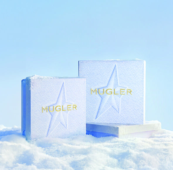 three snow themed Mugler gift boxes in a light icy setting​