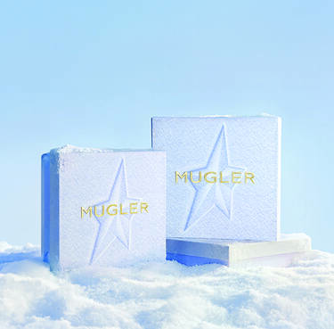 three snow themed Mugler gift boxes in a light icy setting