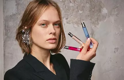 model holding three mini 10ml fragrances