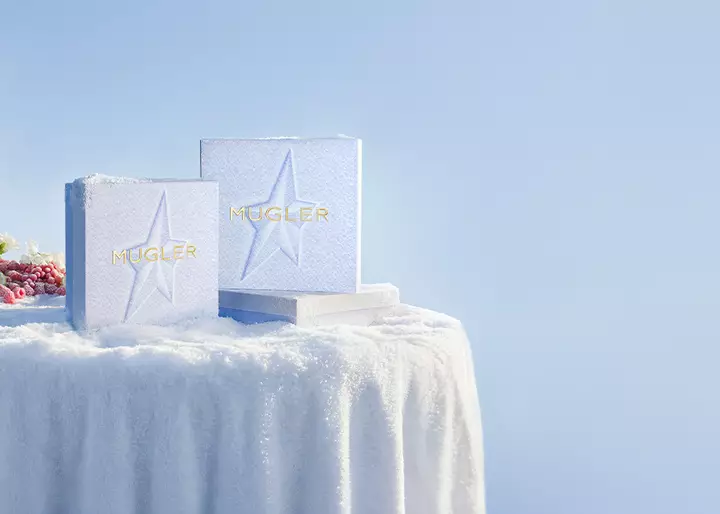 three snow themed Mugler gift boxes in a light icy setting