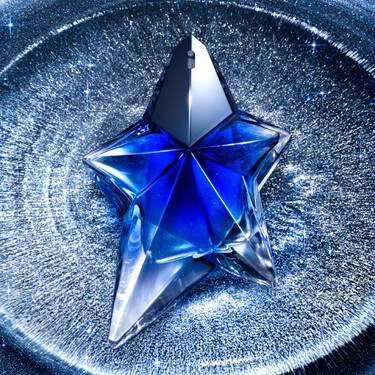 Angel stellar perfume in a blue star shaped bottle, positioned within a tray
