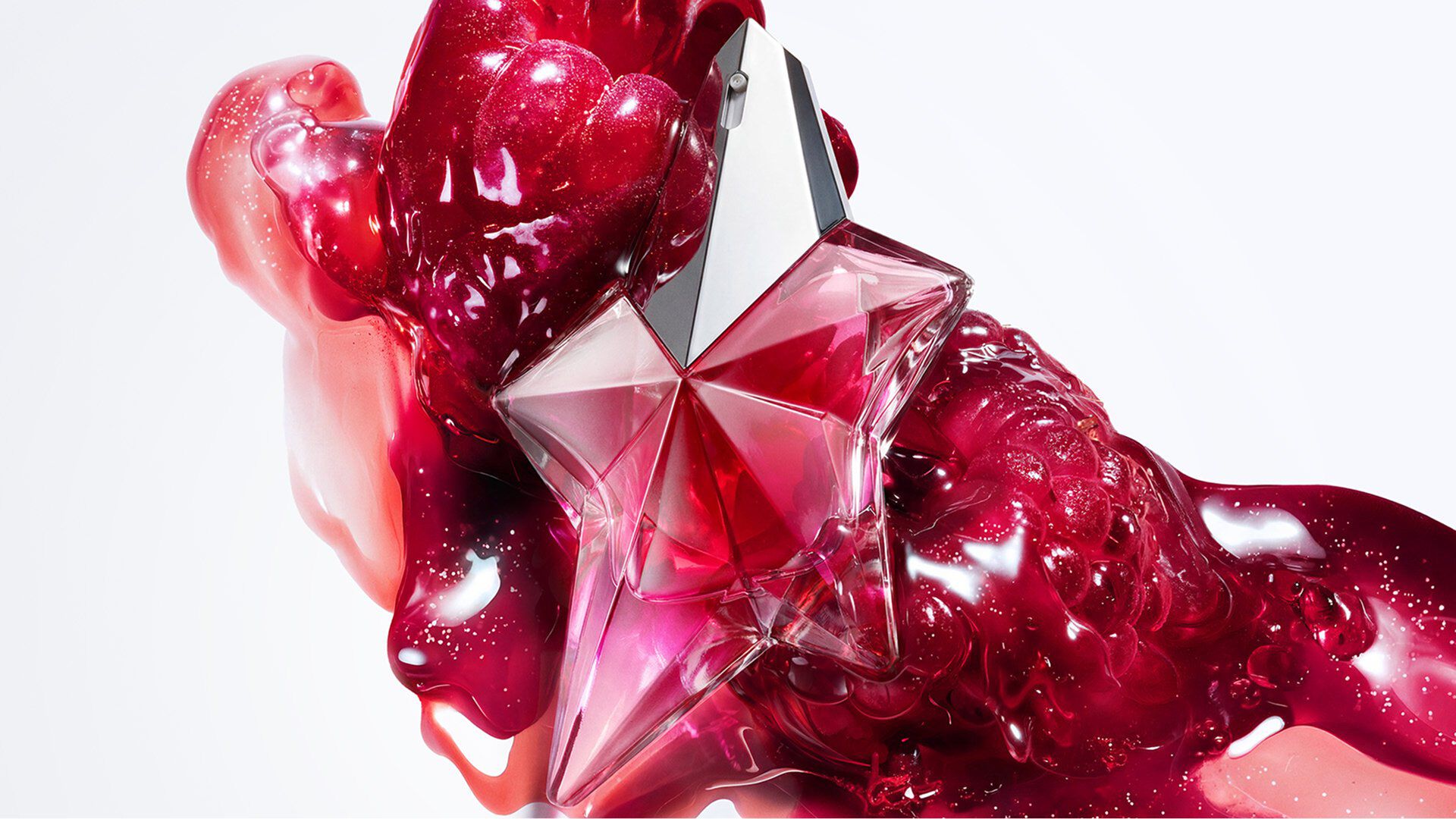 Pink Angel Nova Mugler star perfume bottle with glossy red abstract backdrop