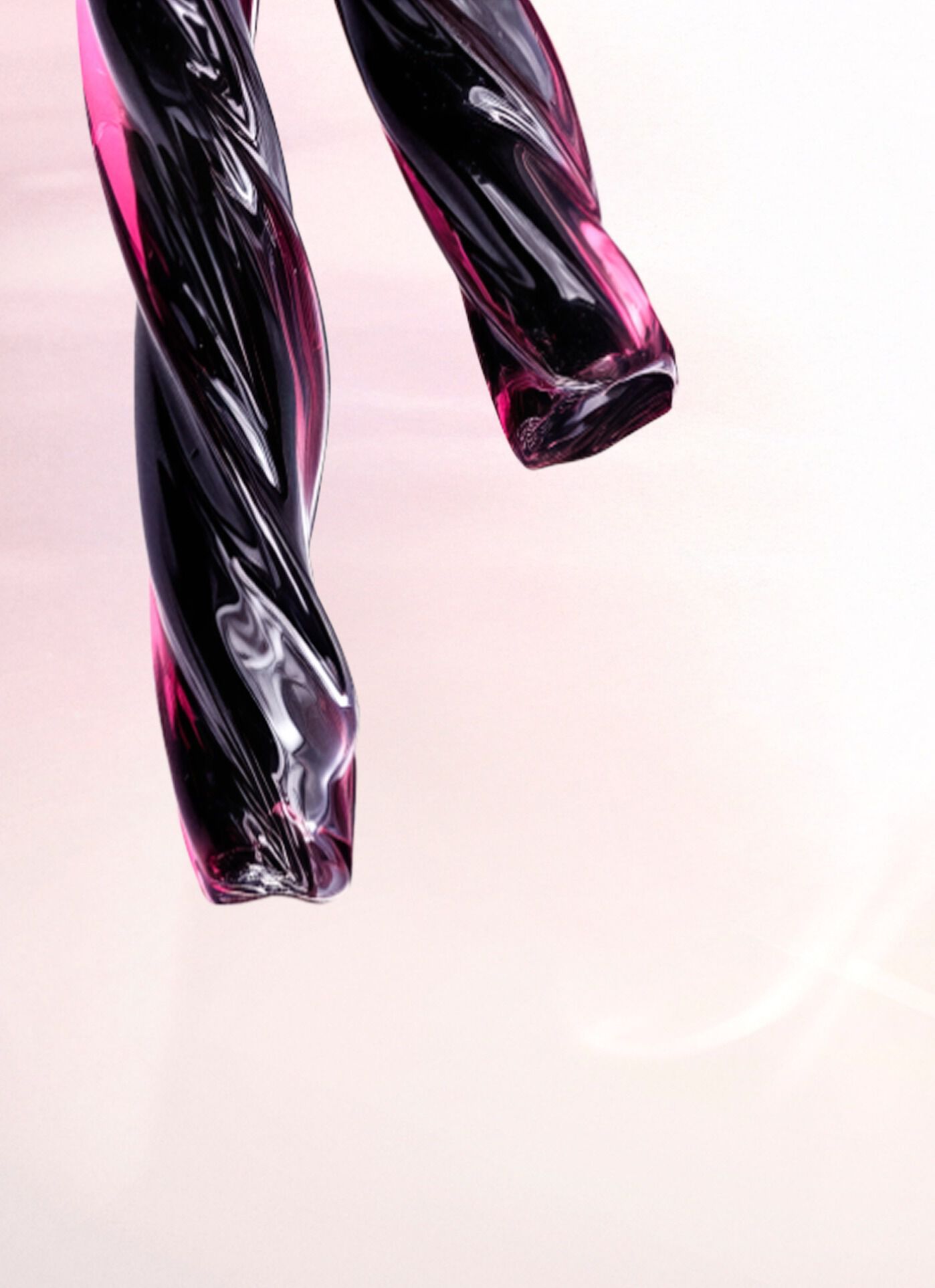 A close-up of two twisted, glossy strands of deep purple and black material resembling licorice. The text describes this as a deep licorice accord that adds contrast and intensity, anchoring the composition of the scent.