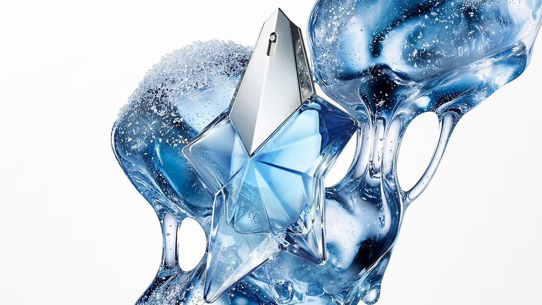 Blue Angel Mugler star perfume bottle with icy, fluid blue abstract backdrop
