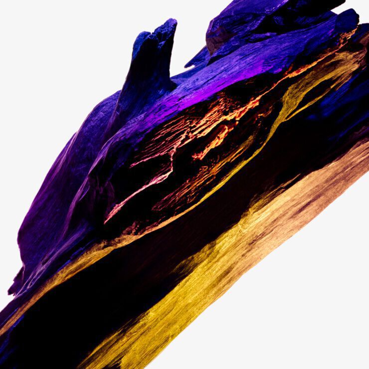 Cashmeran wood ingredient shot with deep purple and golden tones, showcasing the enigmatic musky and exotic wood note of Mugler Alien Perfuming Body Lotion