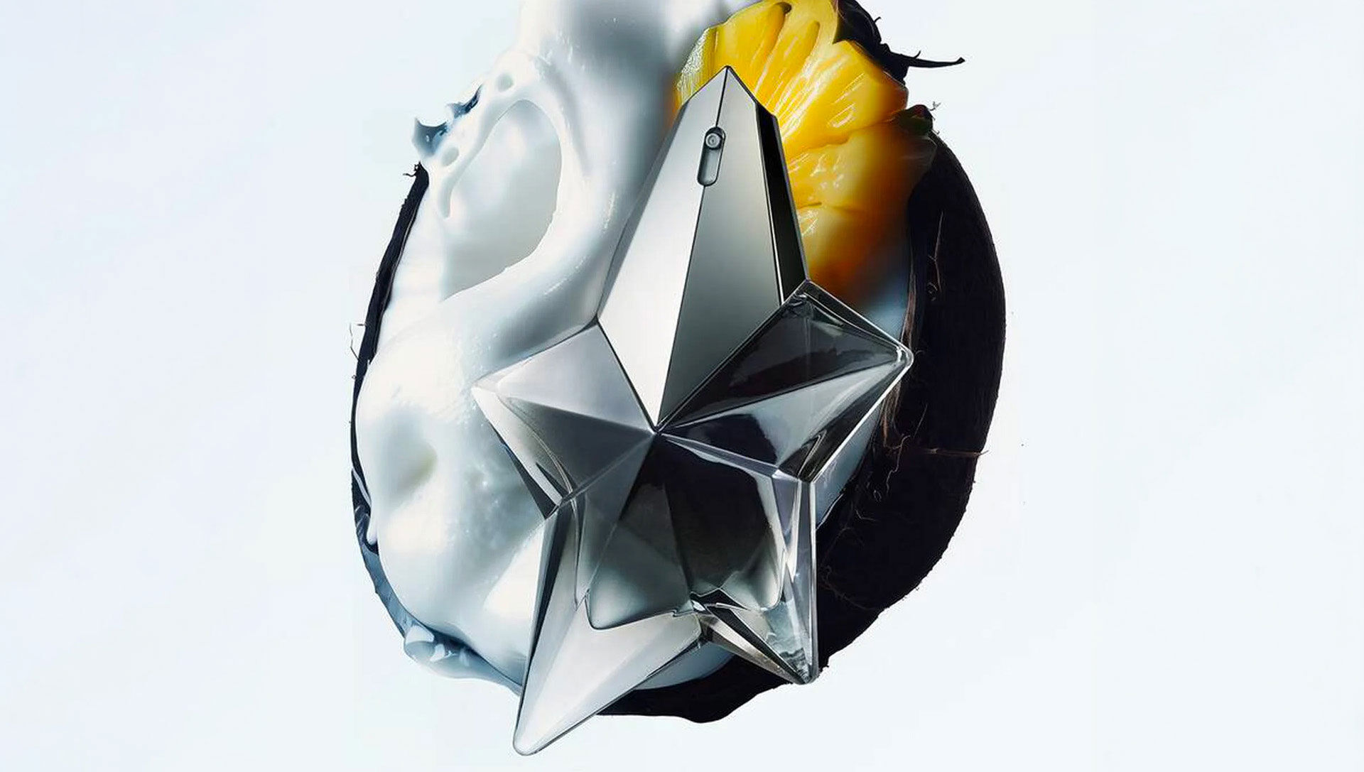 Mugler Angel Fantasm star-shaped bottle with silver fabric and yellow flower, showcasing key fragrance ingredients