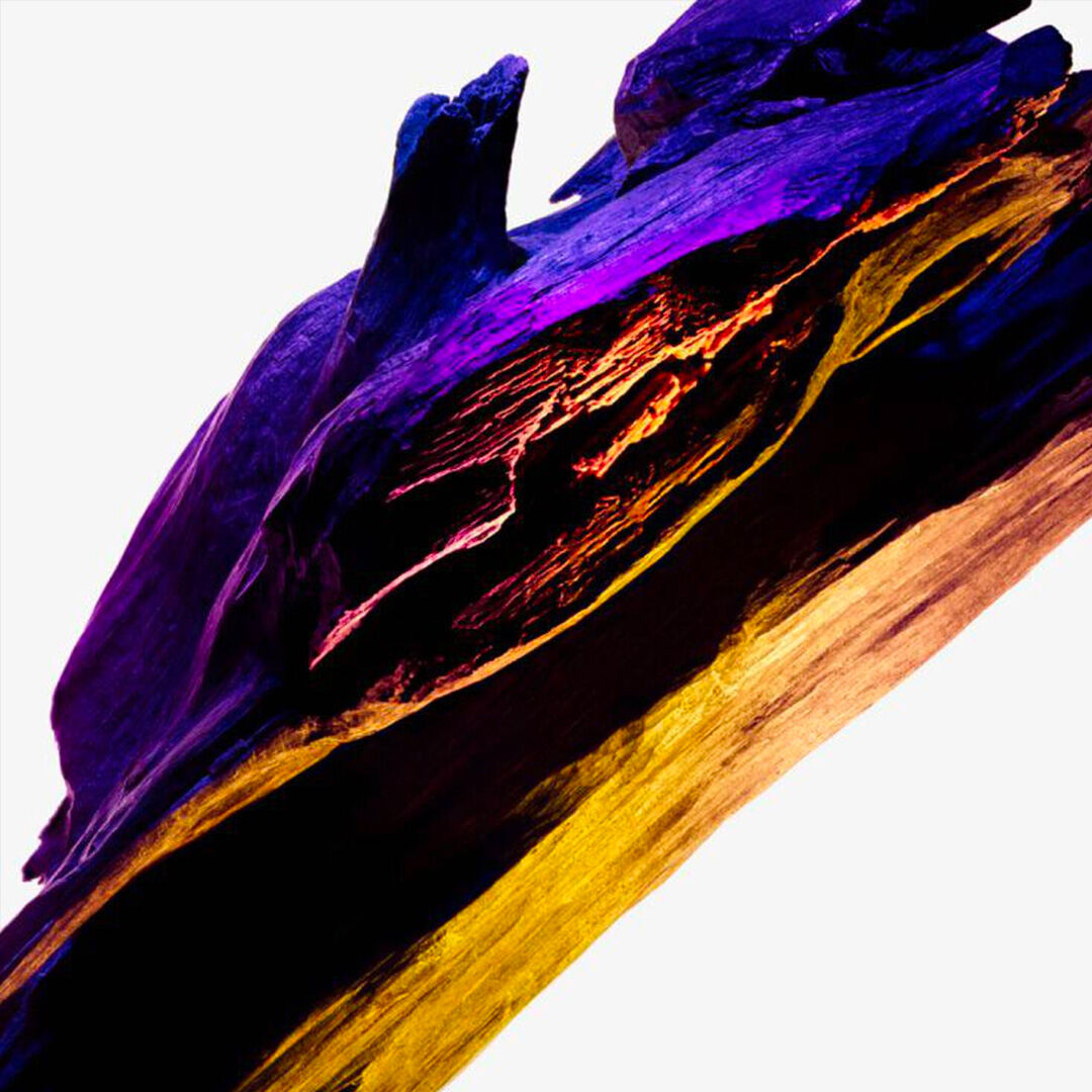 Cashmeran wood ingredient shot with deep purple and golden tones, showcasing the enigmatic musky and exotic wood note of Mugler Alien Perfuming Body Cream