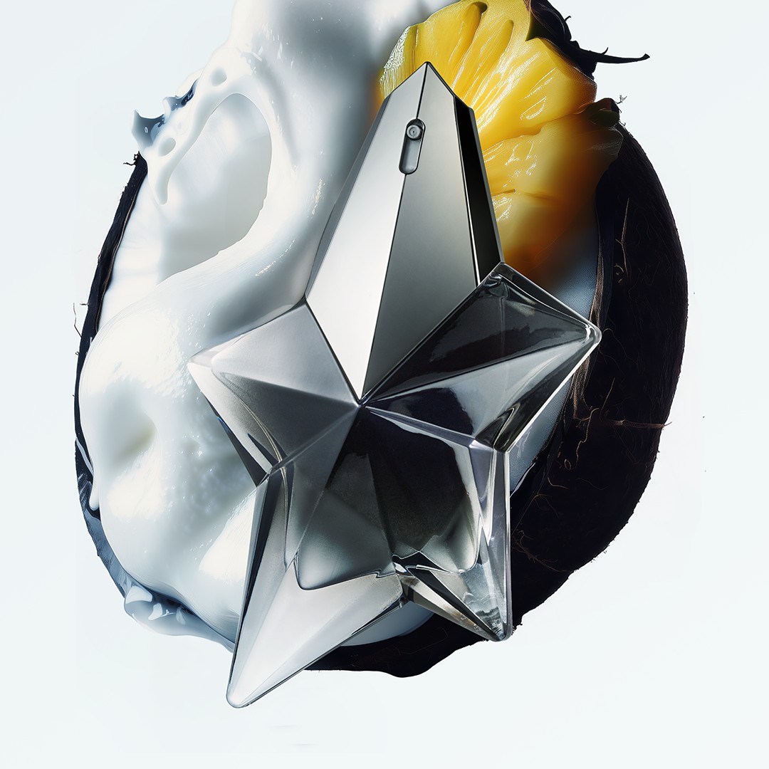 mugler’s angel star bottle against a cosmic, juicy background featuring pineapple and coconut.