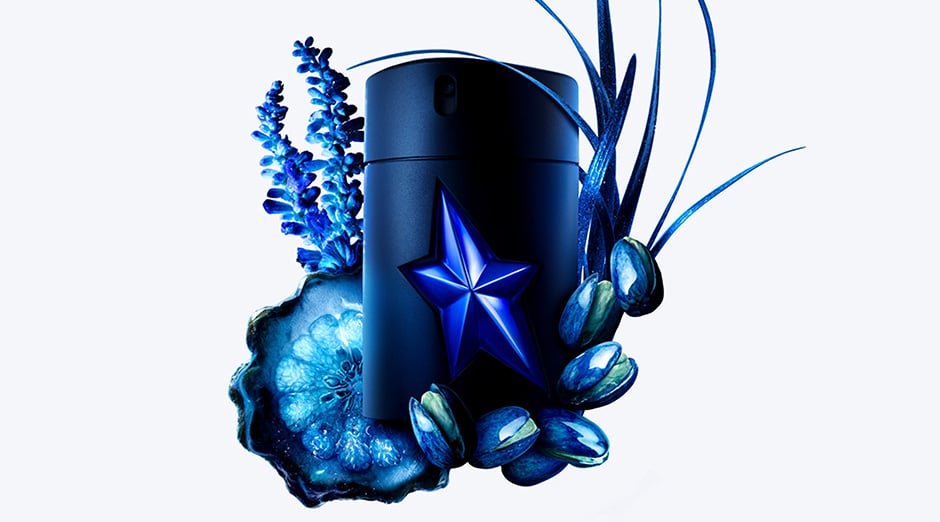 An A*Men Stellar Eau de Parfum bottle is surrounded by the key ingredients of the fragrance- Lavandin, Pistachio and woody accords