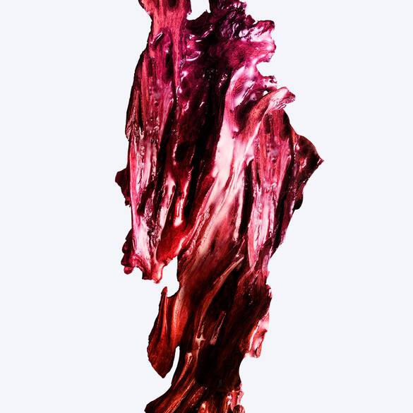 Thick, textured burgundy cream smear with visible ridges on a white background.