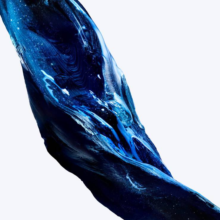 Dynamic swirl of textured deep blue sparkling gel with electric blue highlights on a white background.