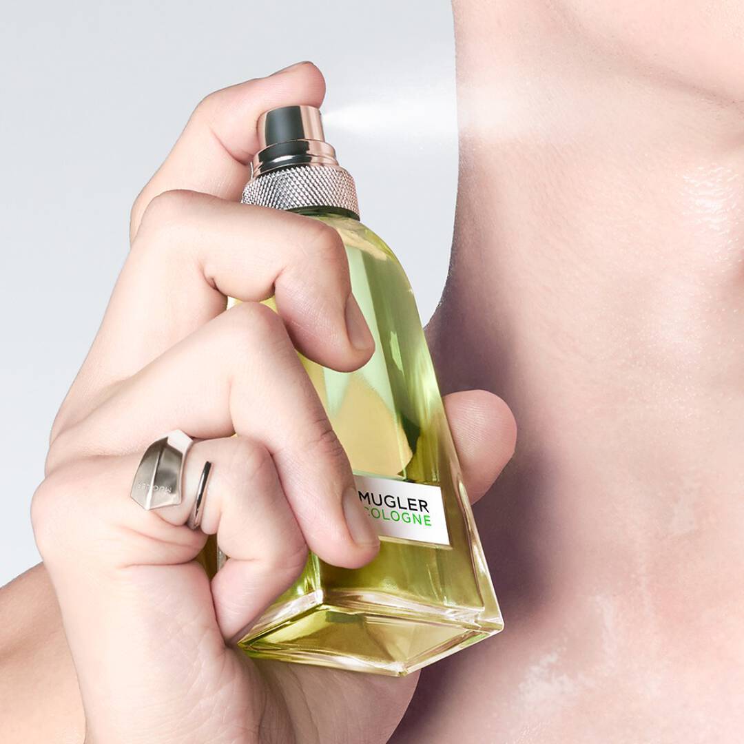 close up of a man spritzing mugler cologne for men on his neck